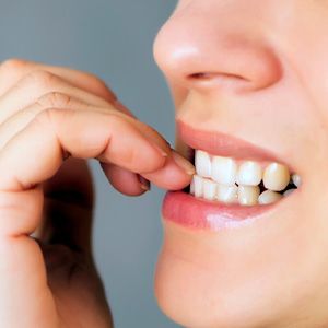 Closeup of woman biting her nails