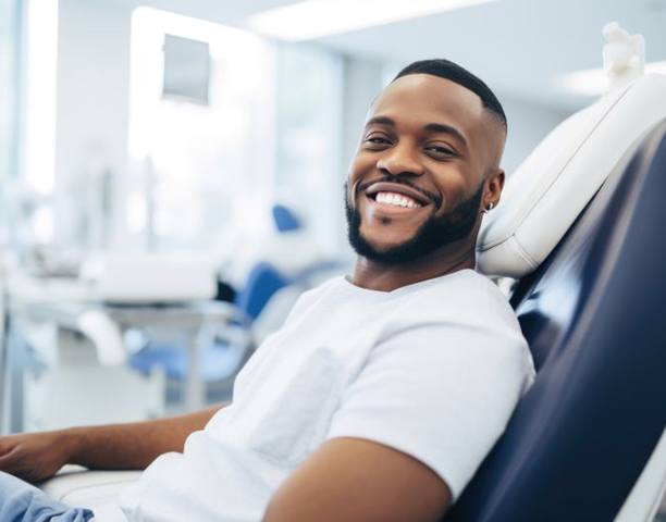 Happy, smiling dental patient in treatment chair