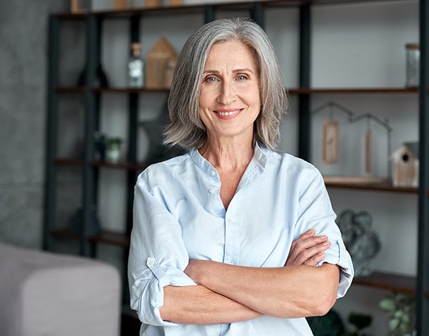 Senior woman smiling with arms folded