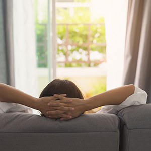 Woman resting on couch at home