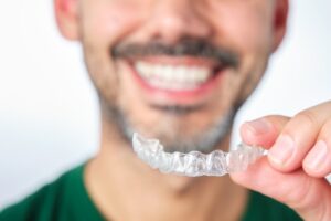 Man with clear dental aligners