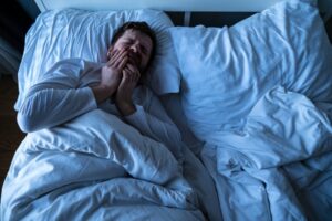 Man with a toothache in bed